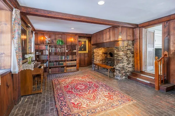 a room with lots of wooden furniture and a rug