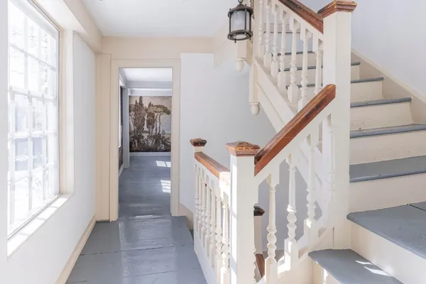 a view of entryway and hall with wooden floor
