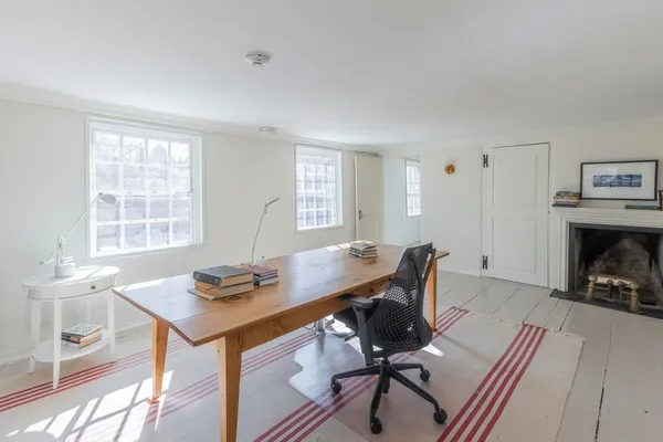 a workspace with furniture and a fireplace