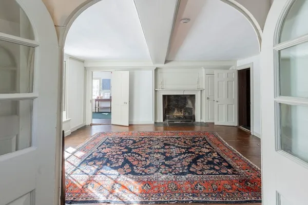 a view of empty room with wooden floor and fireplace