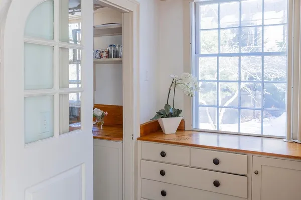 a bathroom with a granite countertop sink and a window