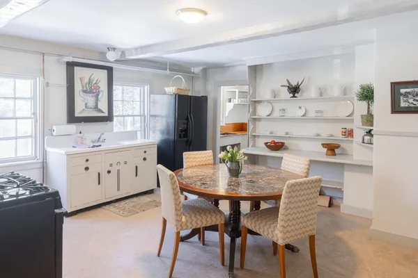 a view of dining table chairs and window