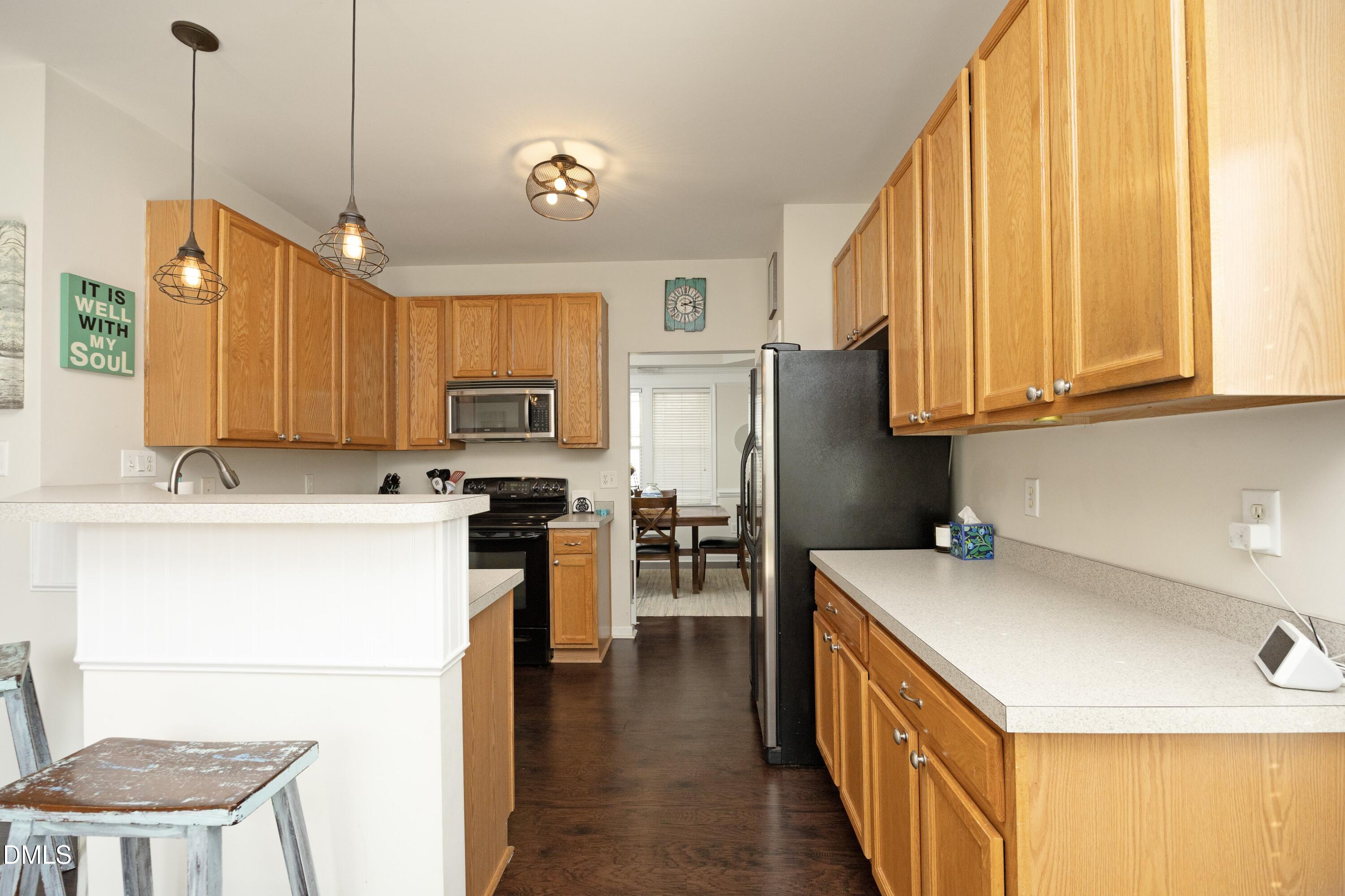 4054 Landover Lane Raleigh, NC 27616 - Photo 11 of 27 a kitchen with a sink a counter top space stainless steel appliances and cabinets