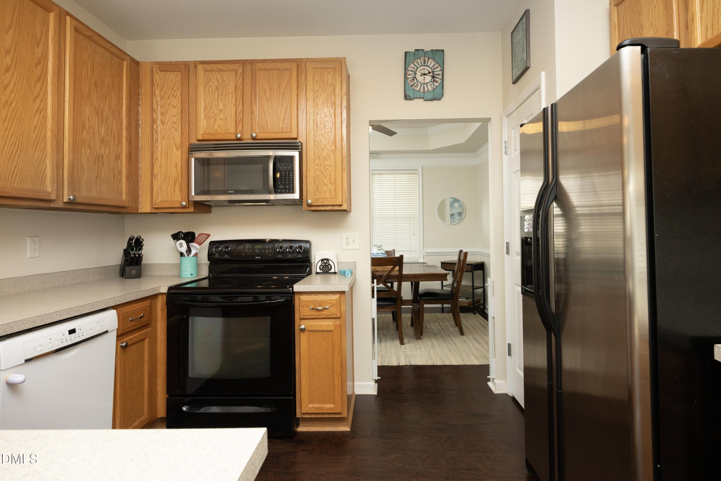 4054 Landover Lane Raleigh, NC 27616 - Photo 12 of 27 a kitchen with granite countertop a refrigerator stove and microwave