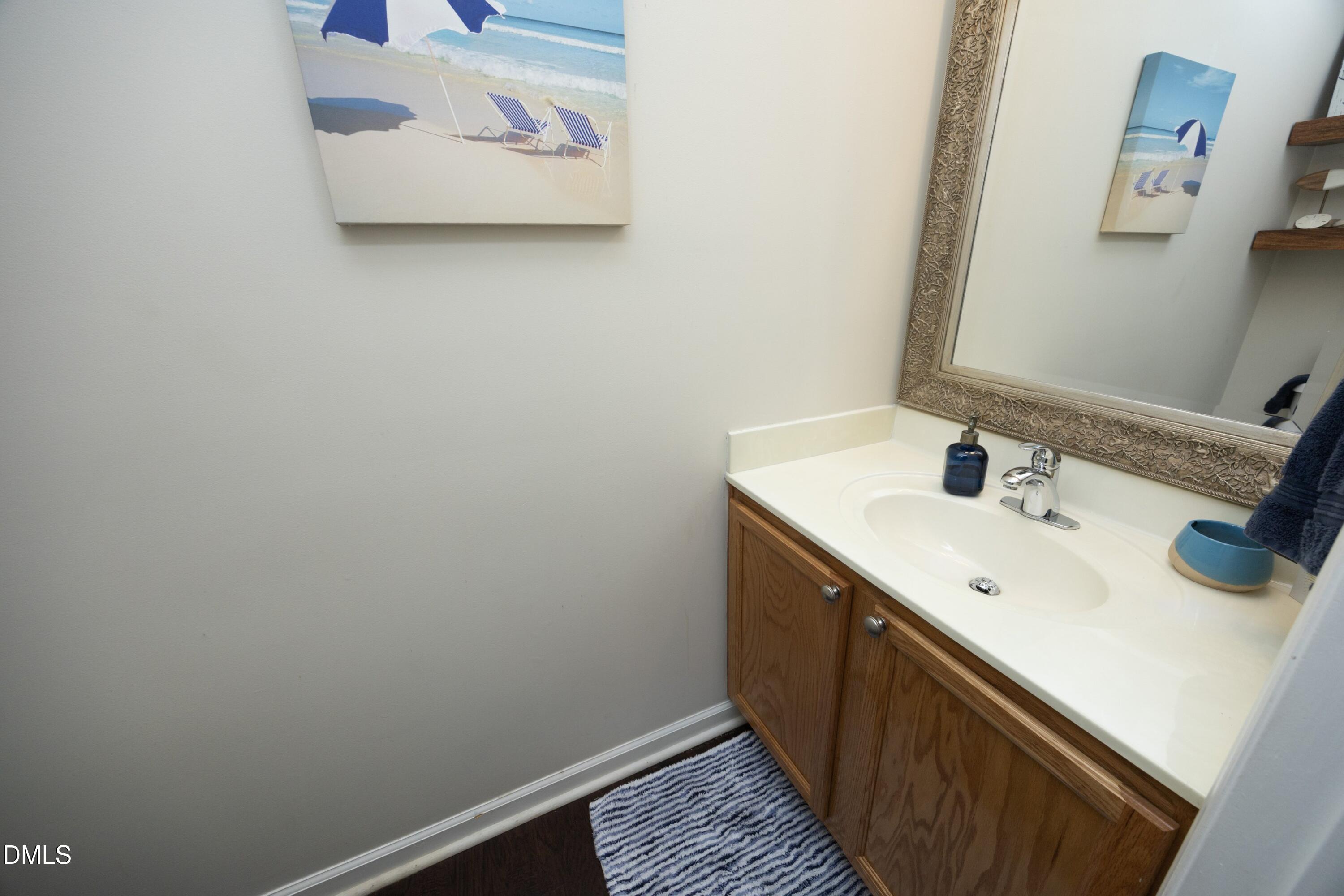 4054 Landover Lane Raleigh, NC 27616 - Photo 14 of 27 a bathroom with a sink and a mirror