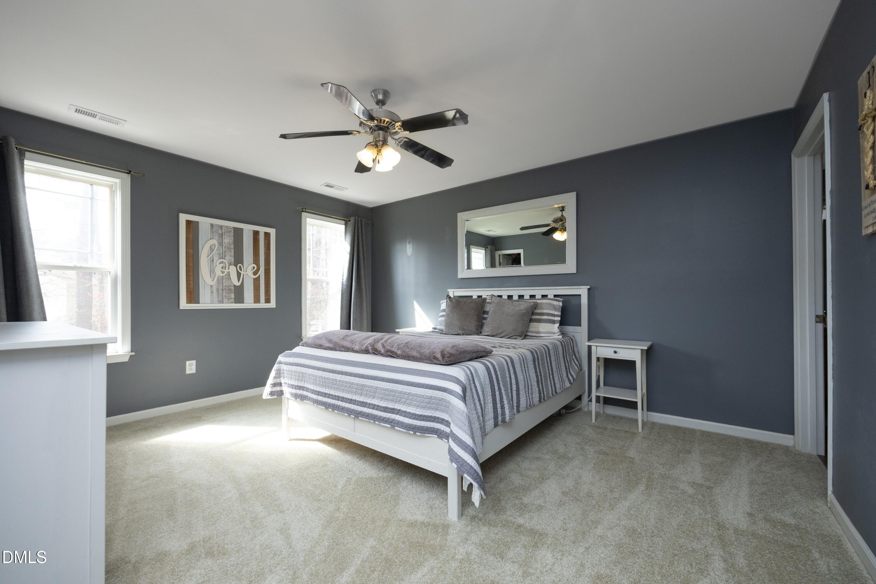 4054 Landover Lane Raleigh, NC 27616 - Photo 15 of 27 a bedroom with a bed wooden floor and window