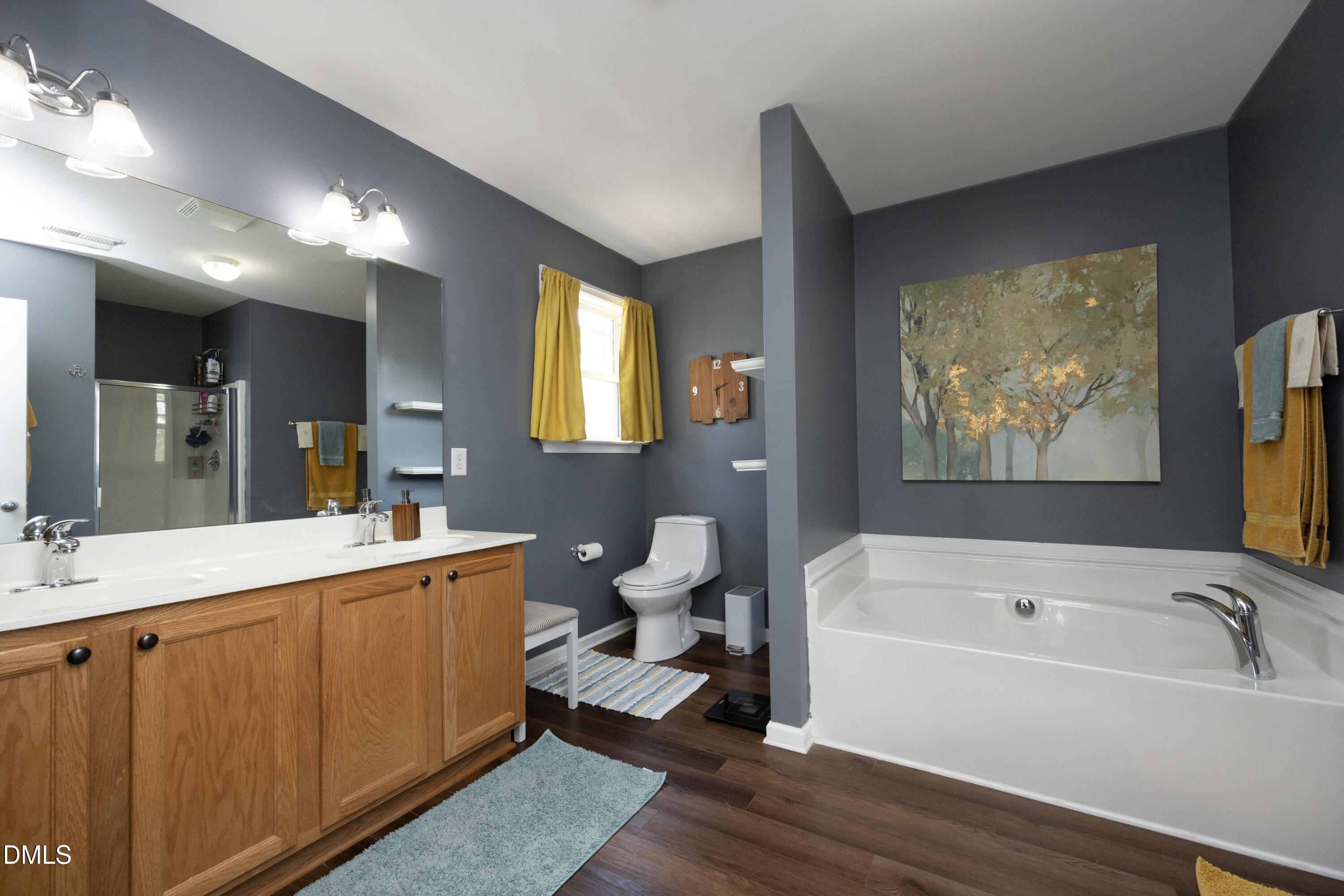 4054 Landover Lane Raleigh, NC 27616 - Photo 16 of 27 a bathroom with a tub a sink and mirror