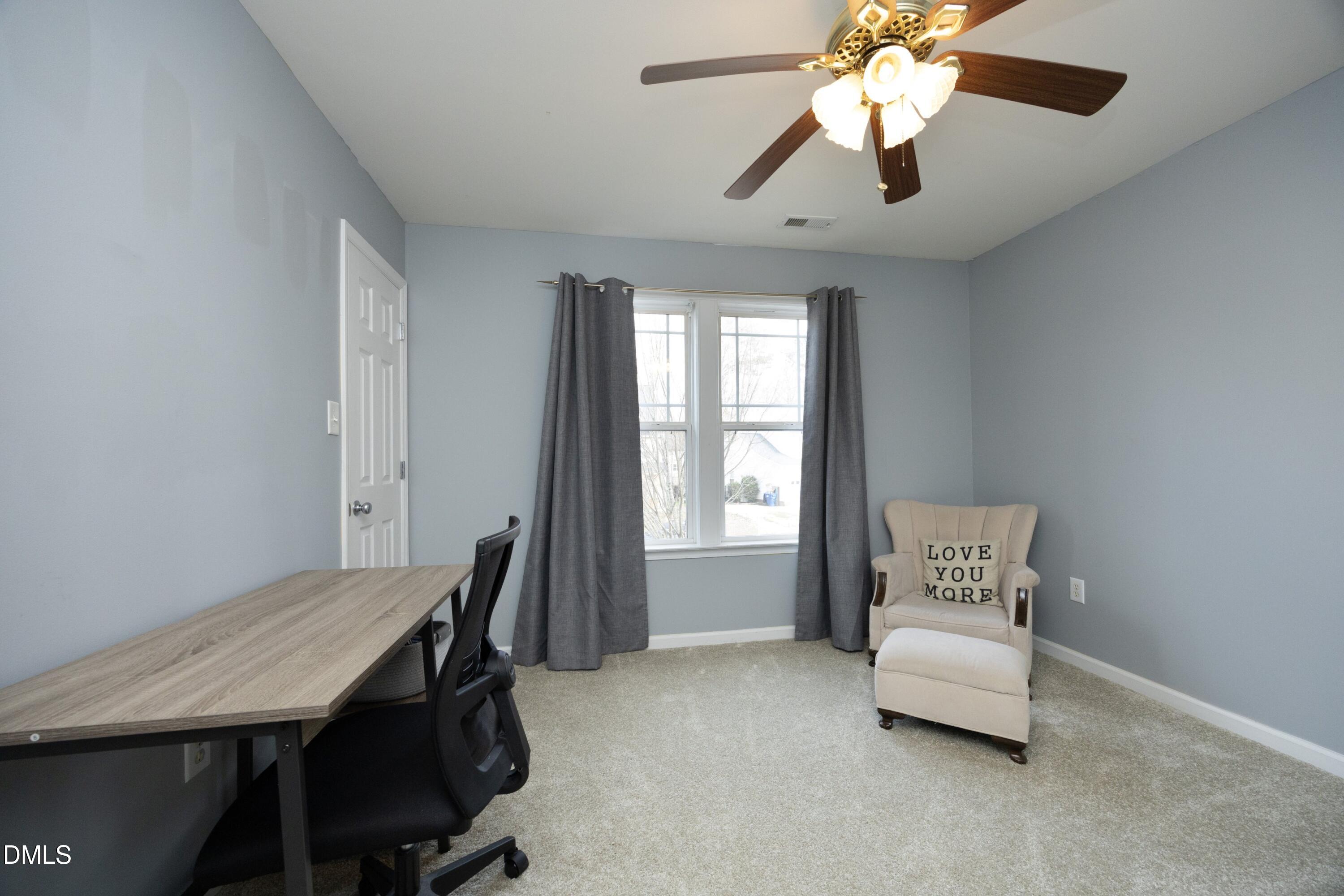 4054 Landover Lane Raleigh, NC 27616 - Photo 19 of 27 a bedroom with a bed and a chandelier fan