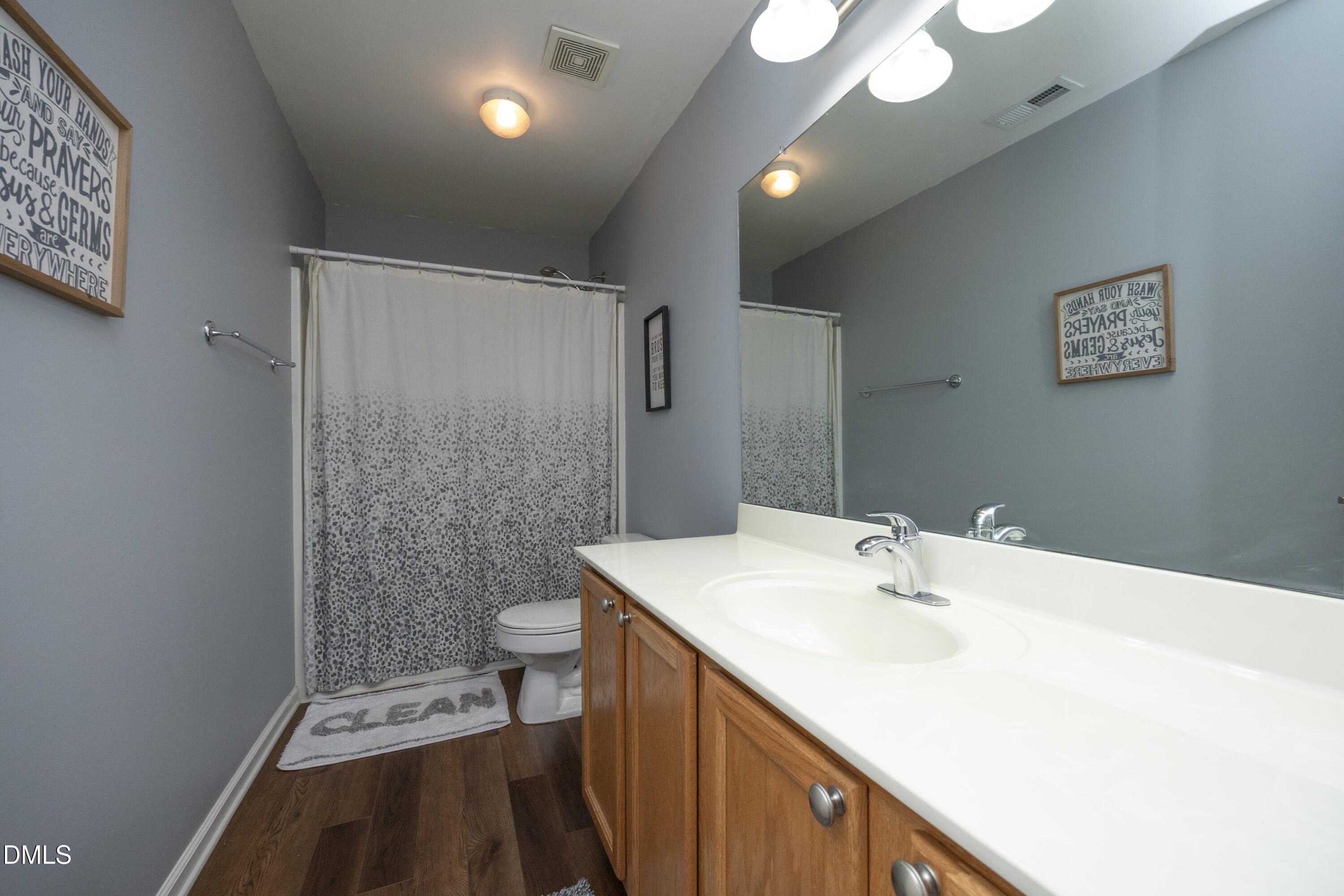 4054 Landover Lane Raleigh, NC 27616 - Photo 20 of 27 a bathroom with a sink a toilet and shower