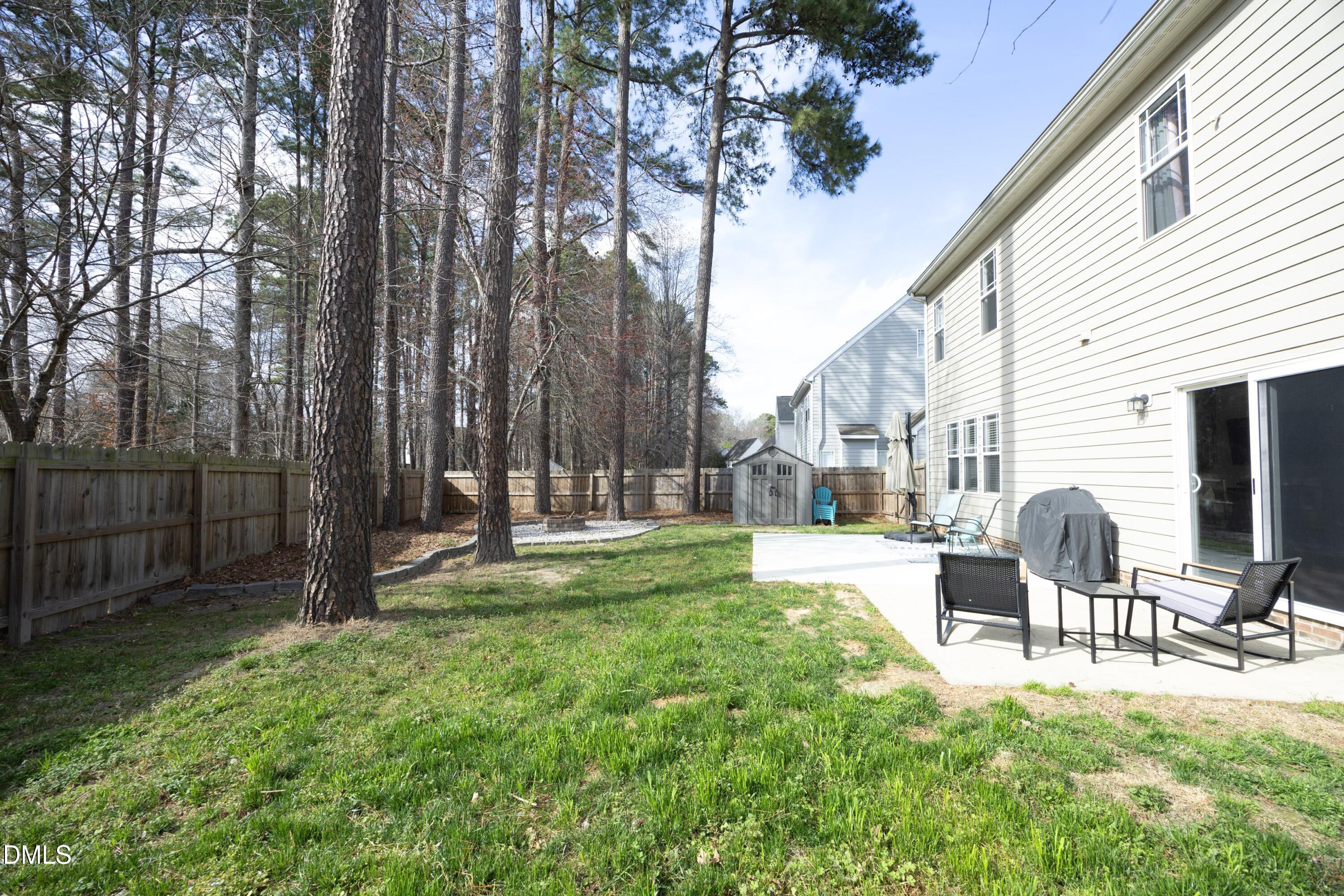 4054 Landover Lane Raleigh, NC 27616 - Photo 23 of 27 a view of backyard of house with outdoor seating and green space