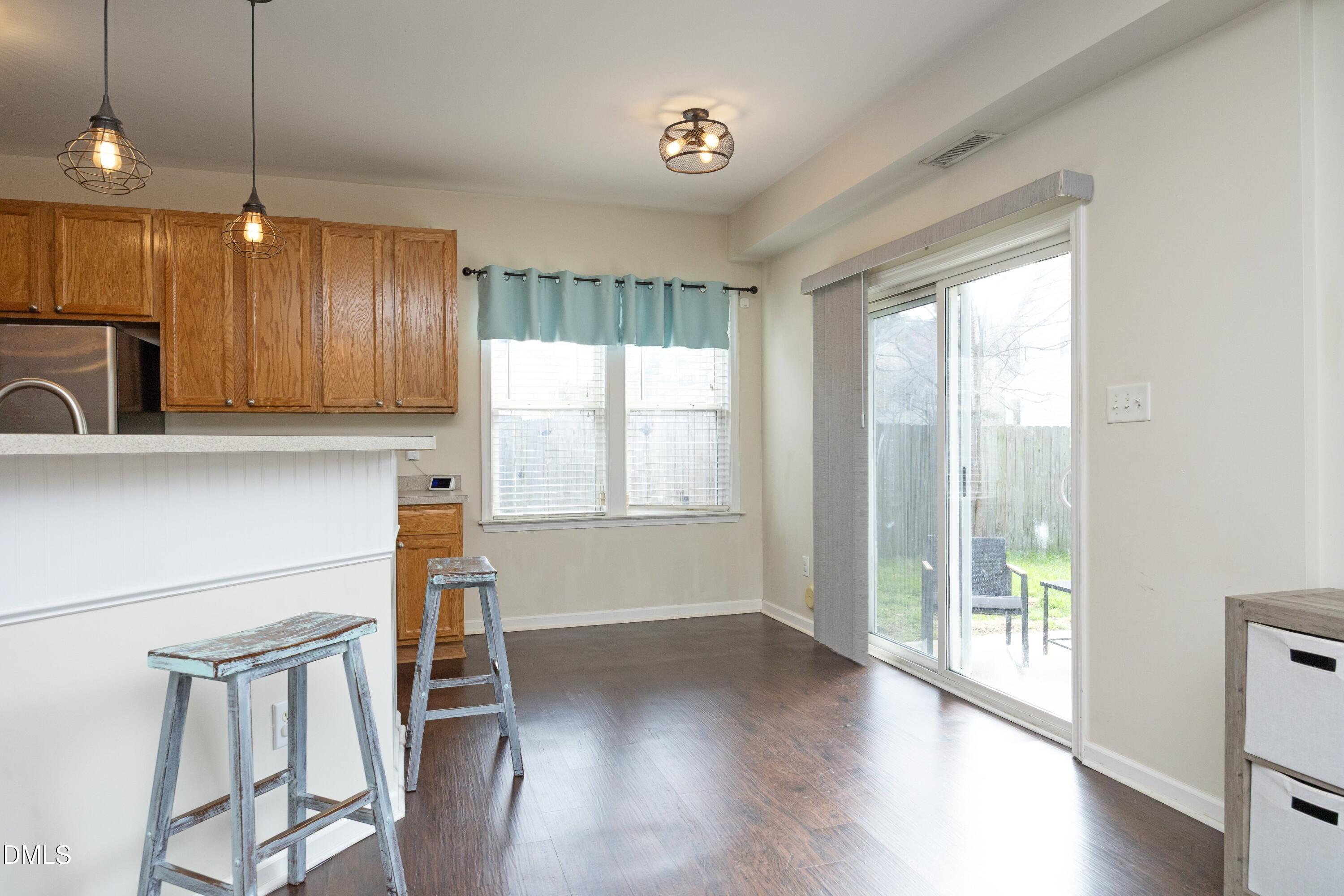 4054 Landover Lane Raleigh, NC 27616 - Photo 10 of 27 a view of a kitchen with wooden floor and a window