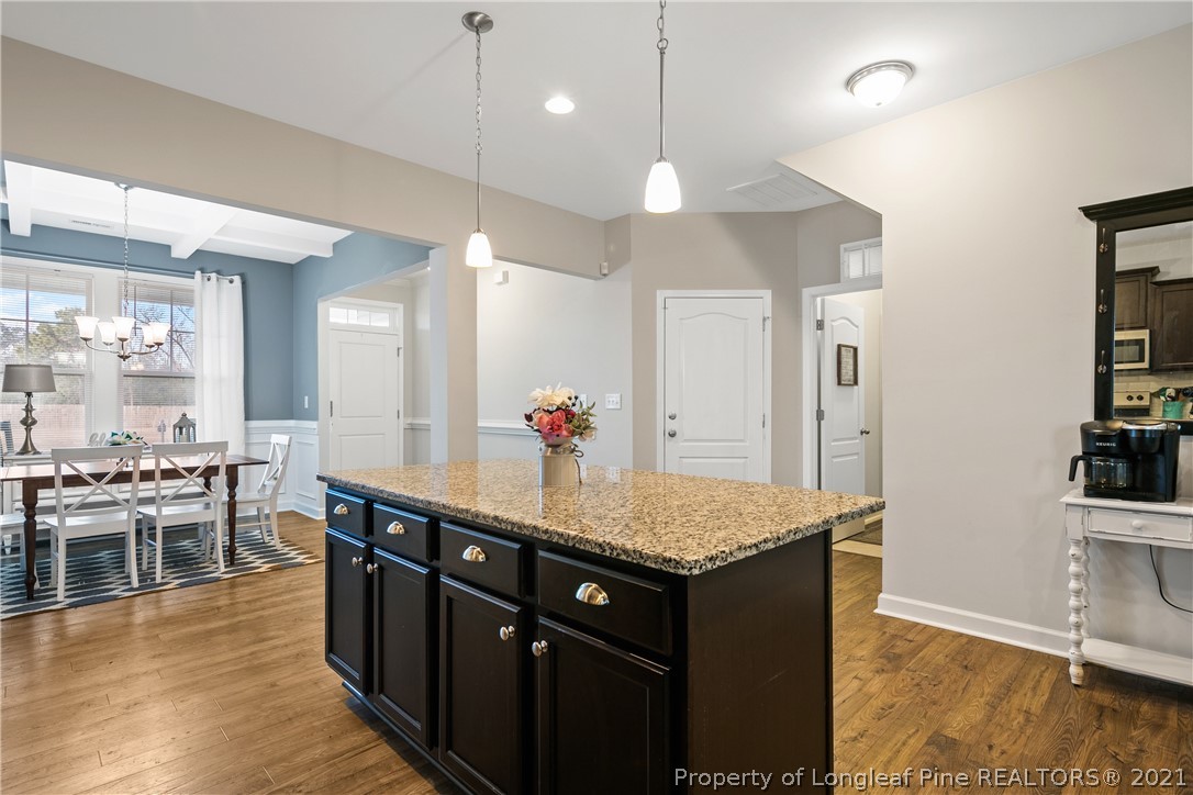 244 Mill Ridge Court Godwin, NC 28344 - Photo 15 of 50 a kitchen with stainless steel appliances granite countertop a sink a stove and a wooden floors