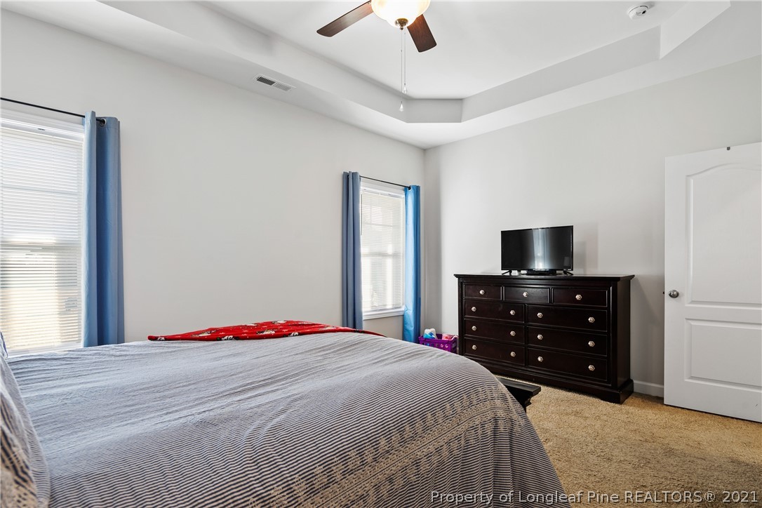 244 Mill Ridge Court Godwin, NC 28344 - Photo 24 of 50 a bedroom with a bed and a flat screen tv