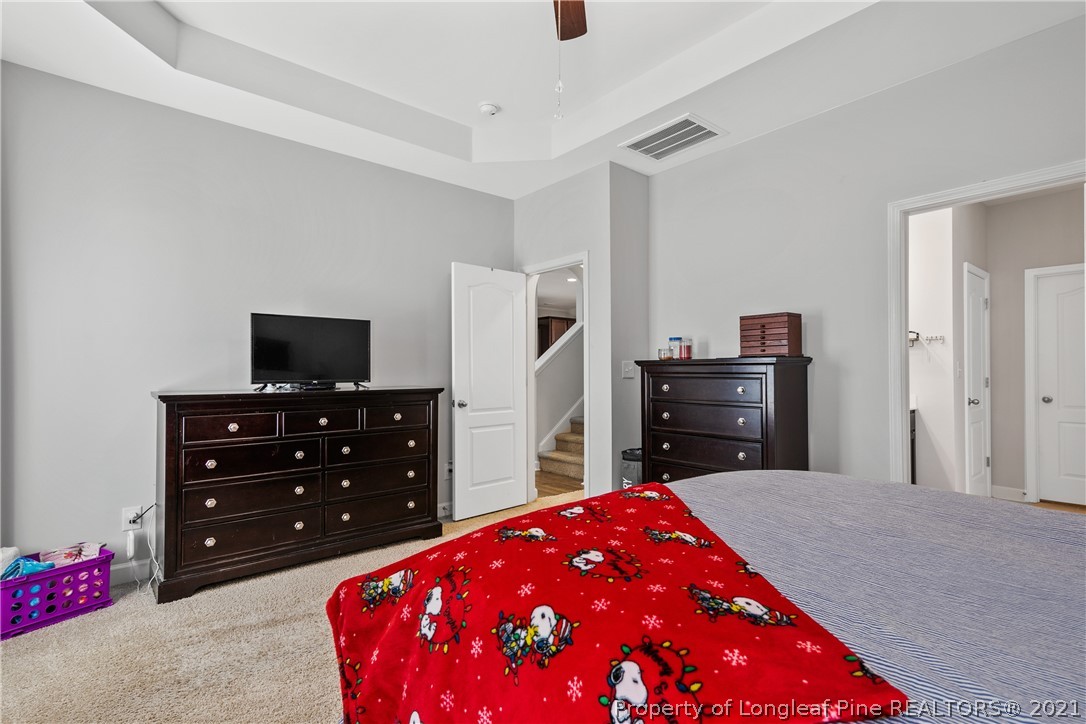 244 Mill Ridge Court Godwin, NC 28344 - Photo 25 of 50 a bedroom with a dresser and a flat screen tv