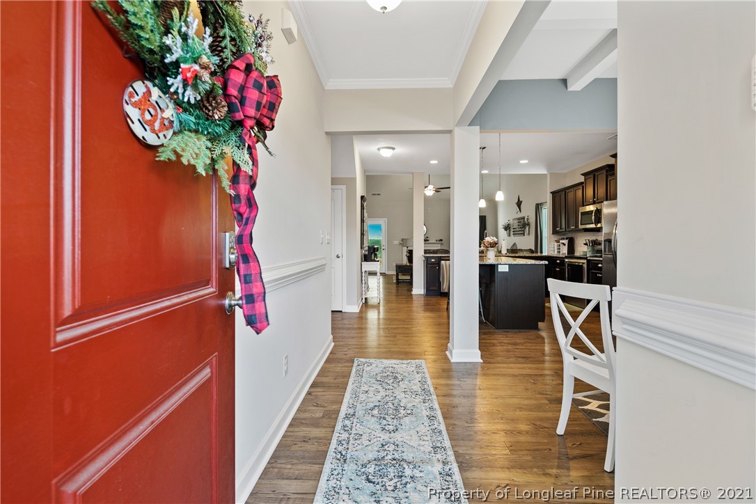 244 Mill Ridge Court Godwin, NC 28344 - Photo 5 of 50 a hallway with wooden floor and a potted plant