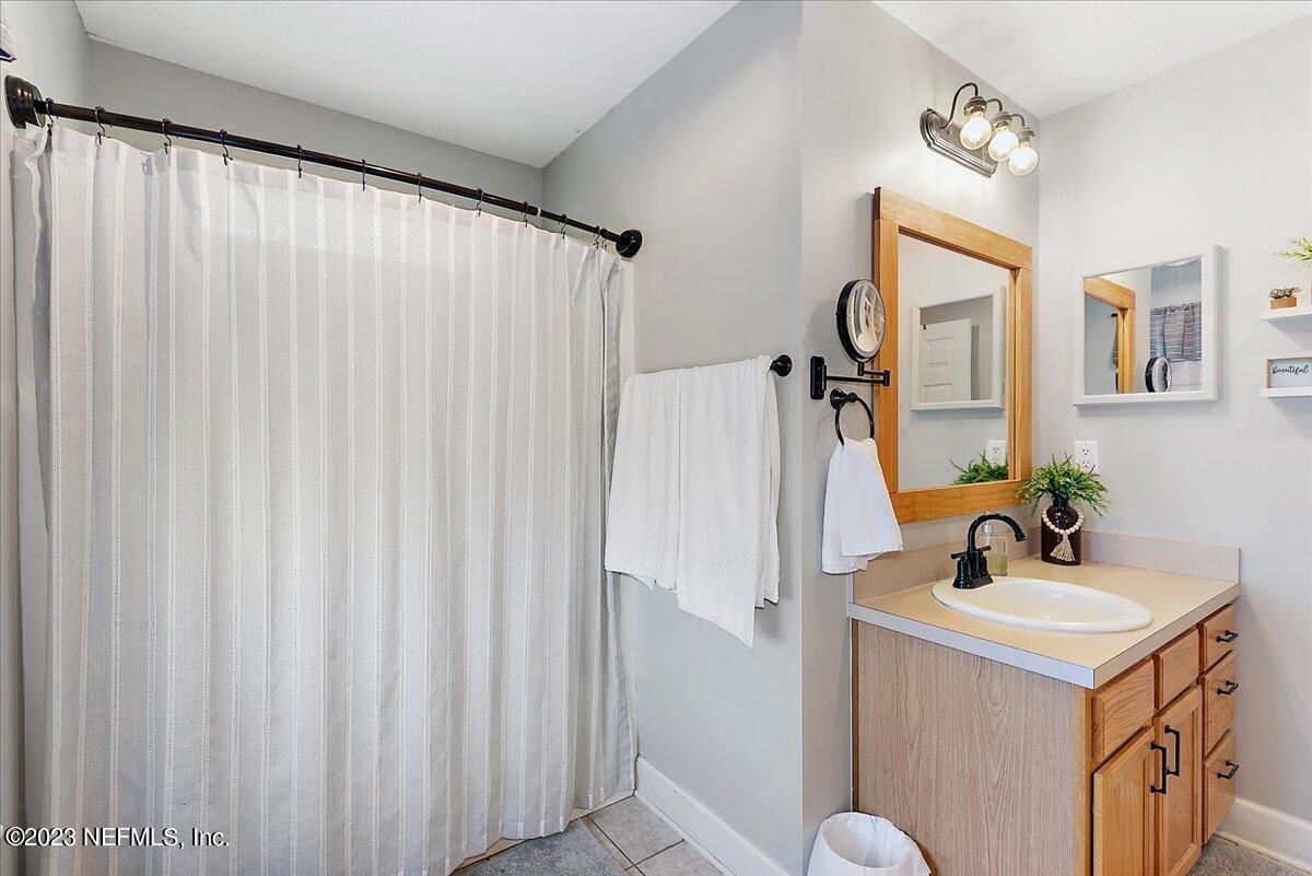 567 Timberlane Drive Macclenny, FL 32063 - Photo 12 of 16 a bathroom with a double vanity sink and mirror