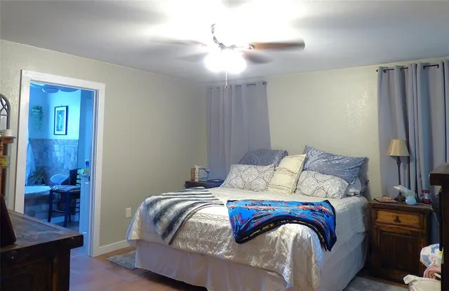 a bedroom with bed and wooden floor
