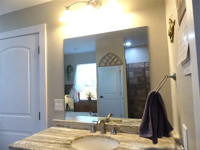 a bathroom with a sink and a mirror