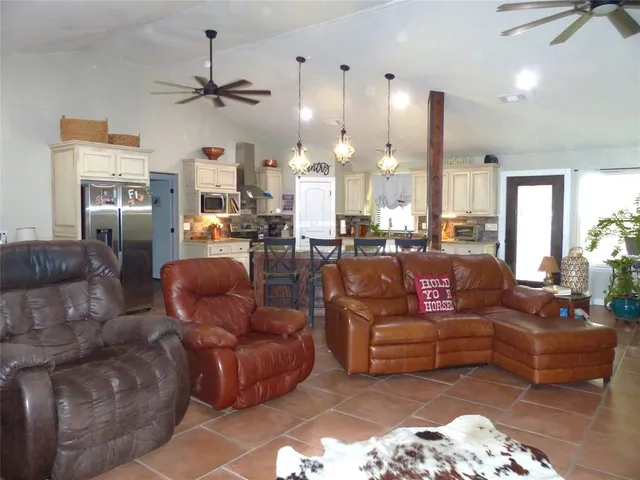 a living room with furniture and a chandelier