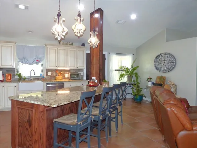 a view of a dining room with furniture and chandelier