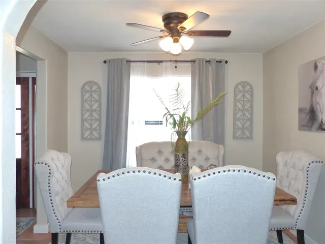 a dining room with furniture and window