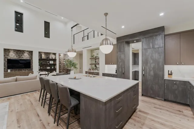 a living room with furniture a chandelier and a dining table