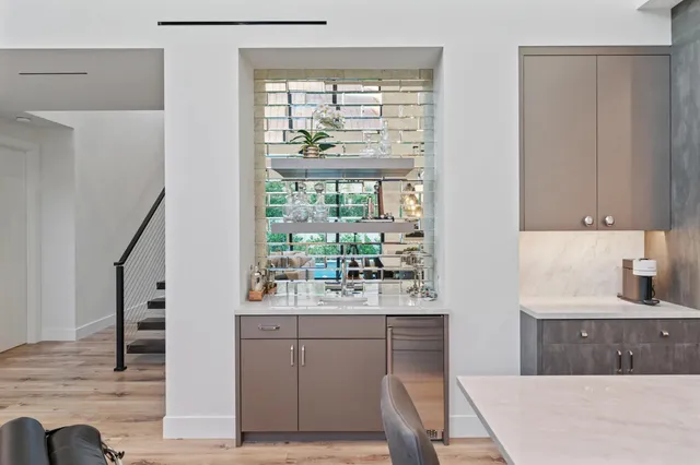 a bed sitting in a bedroom next to a large window