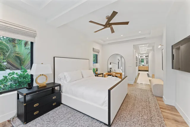 a bedroom with a bed a couch and a window