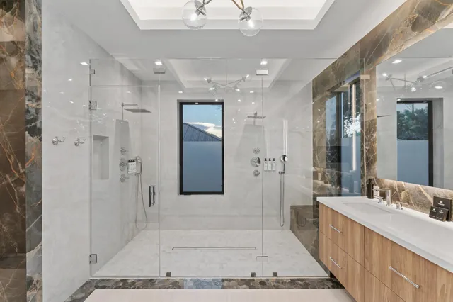 a bathroom with a sink tub and a mirror