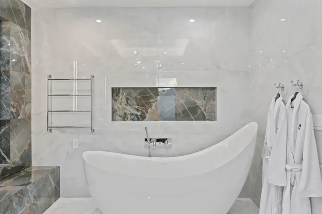 a large white bed in a white room