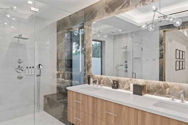 a bedroom with a large bed and a chandelier