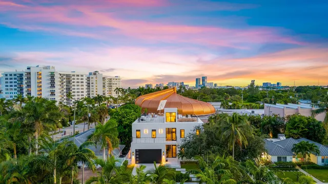 a view of a city with tall buildings and a yard