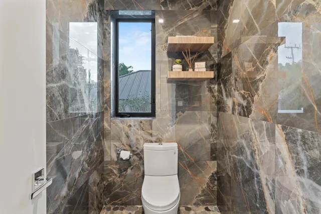 a roof deck with couches and potted plants with sky view