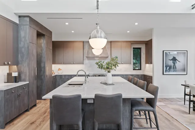 a large kitchen with a table and chairs