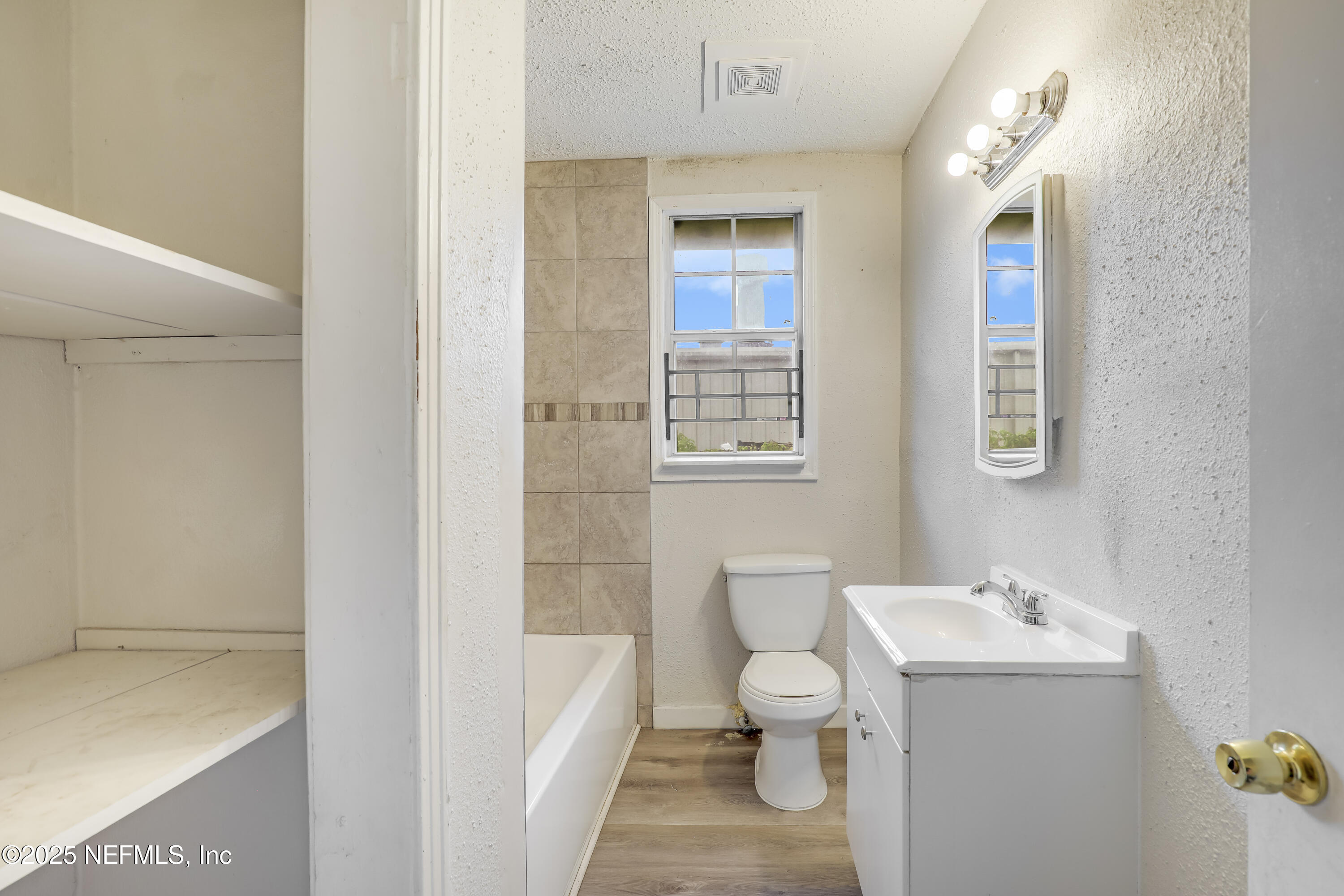 330 West 26th Street Jacksonville, FL 32206 - Photo 11 of 27 a bathroom with a sink a toilet and shower