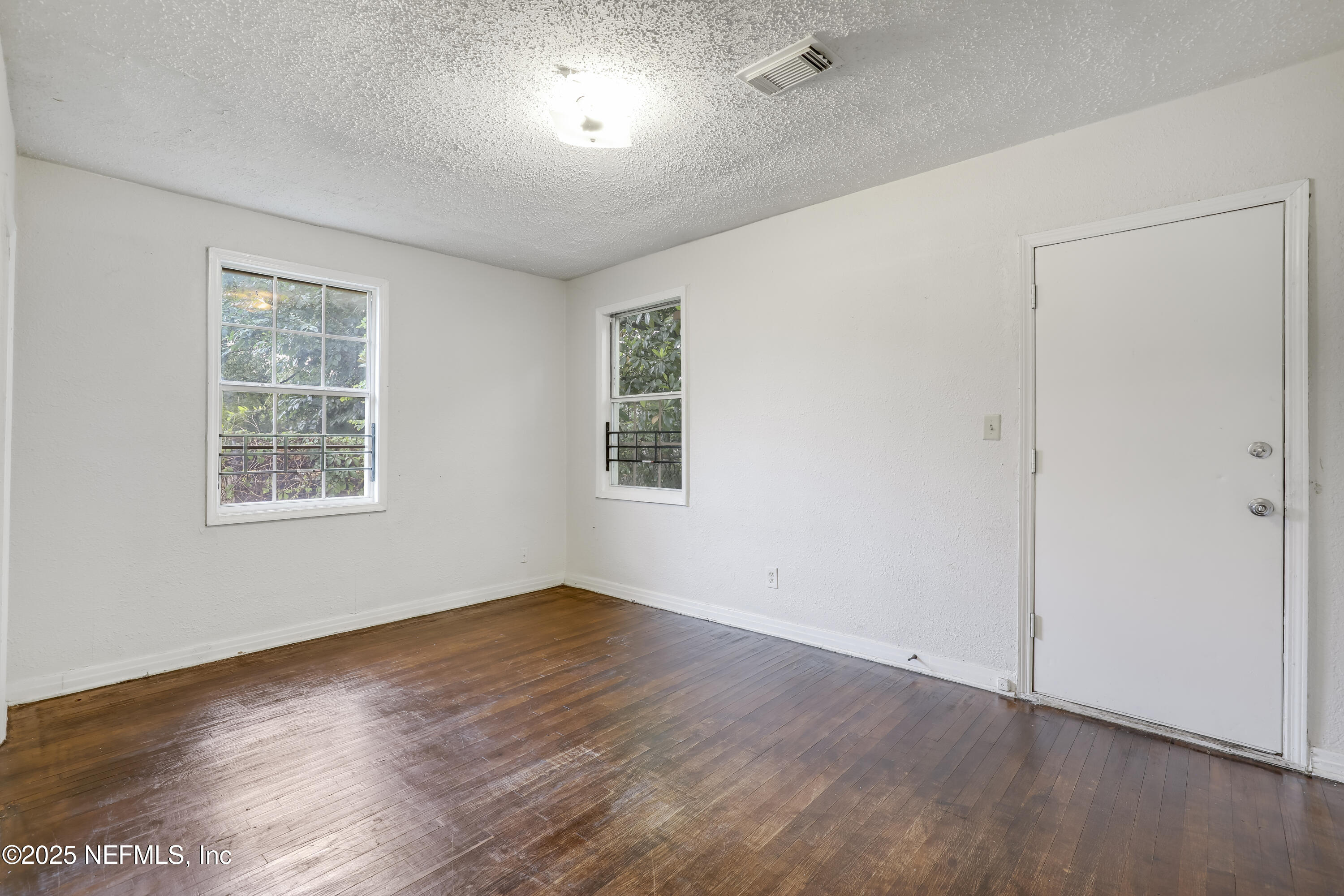 330 West 26th Street Jacksonville, FL 32206 - Photo 14 of 27 an empty room with wooden floor and windows