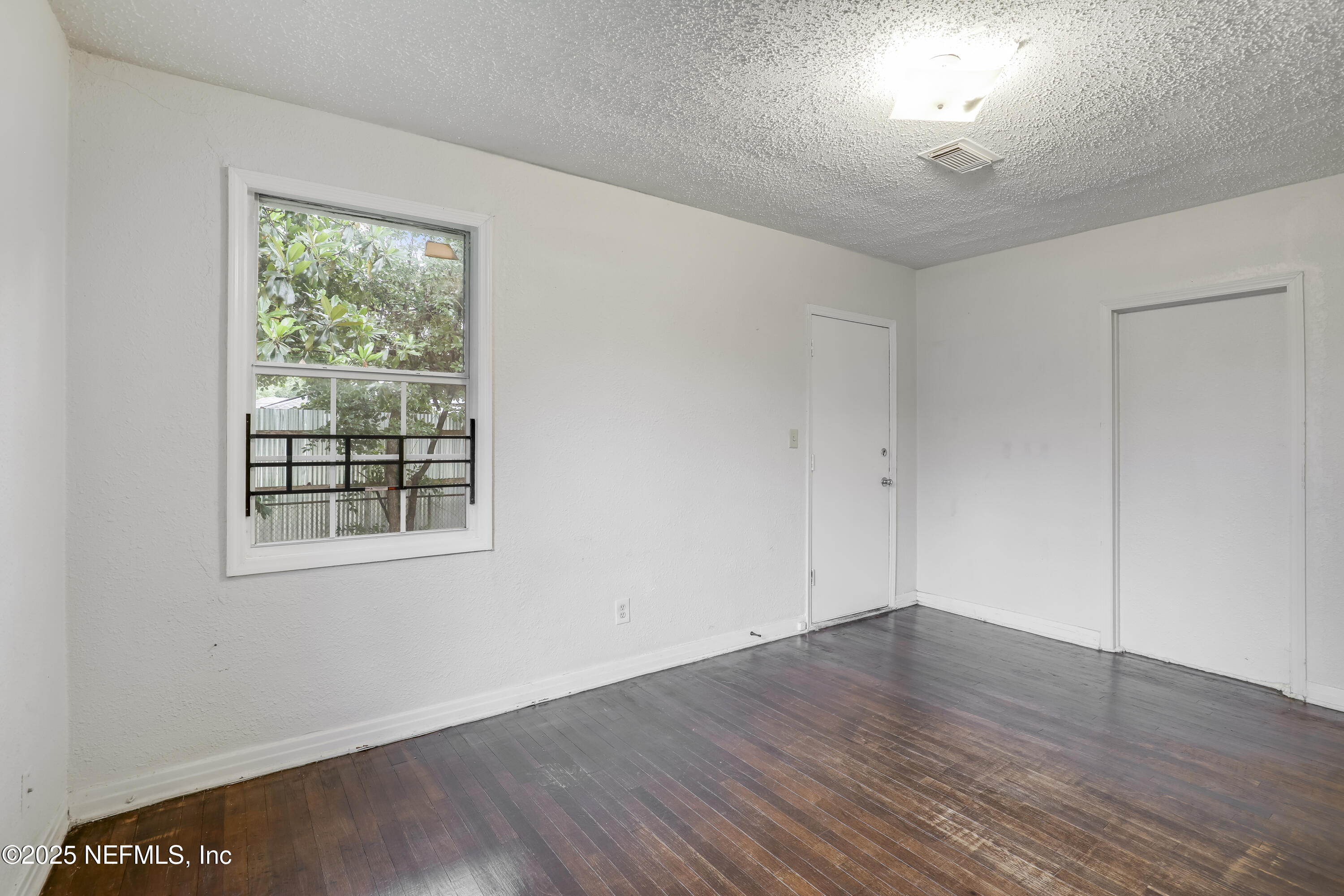 330 West 26th Street Jacksonville, FL 32206 - Photo 15 of 27 a view of an empty room with wooden floor and a window