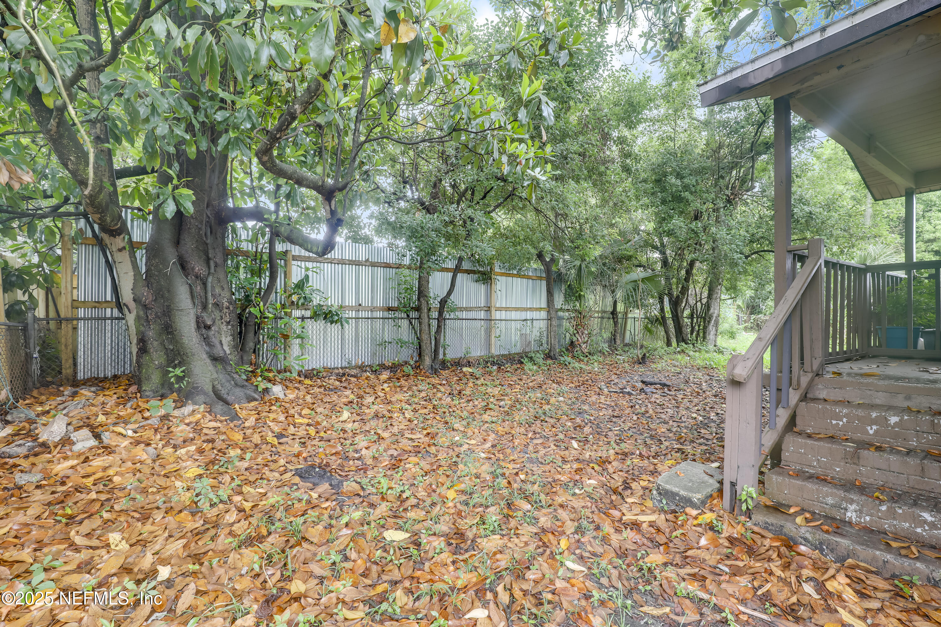 330 West 26th Street Jacksonville, FL 32206 - Photo 17 of 27 a backyard of a house with large trees and wooden fence