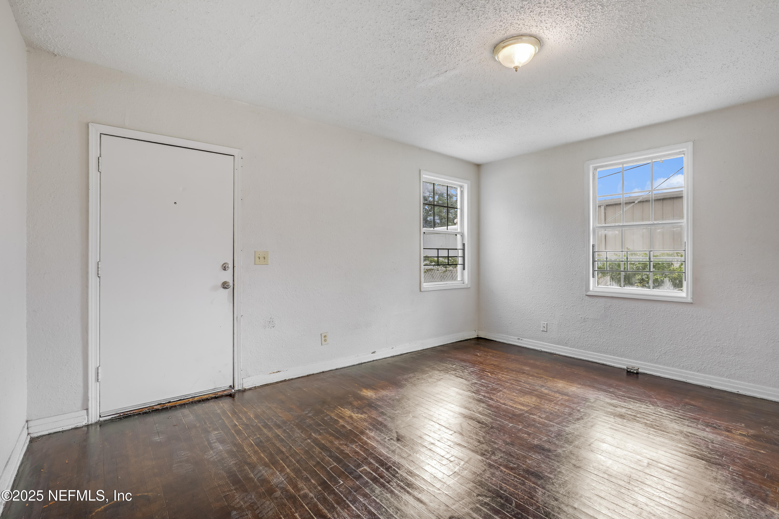 330 West 26th Street Jacksonville, FL 32206 - Photo 2 of 27 an empty room with wooden floor and windows
