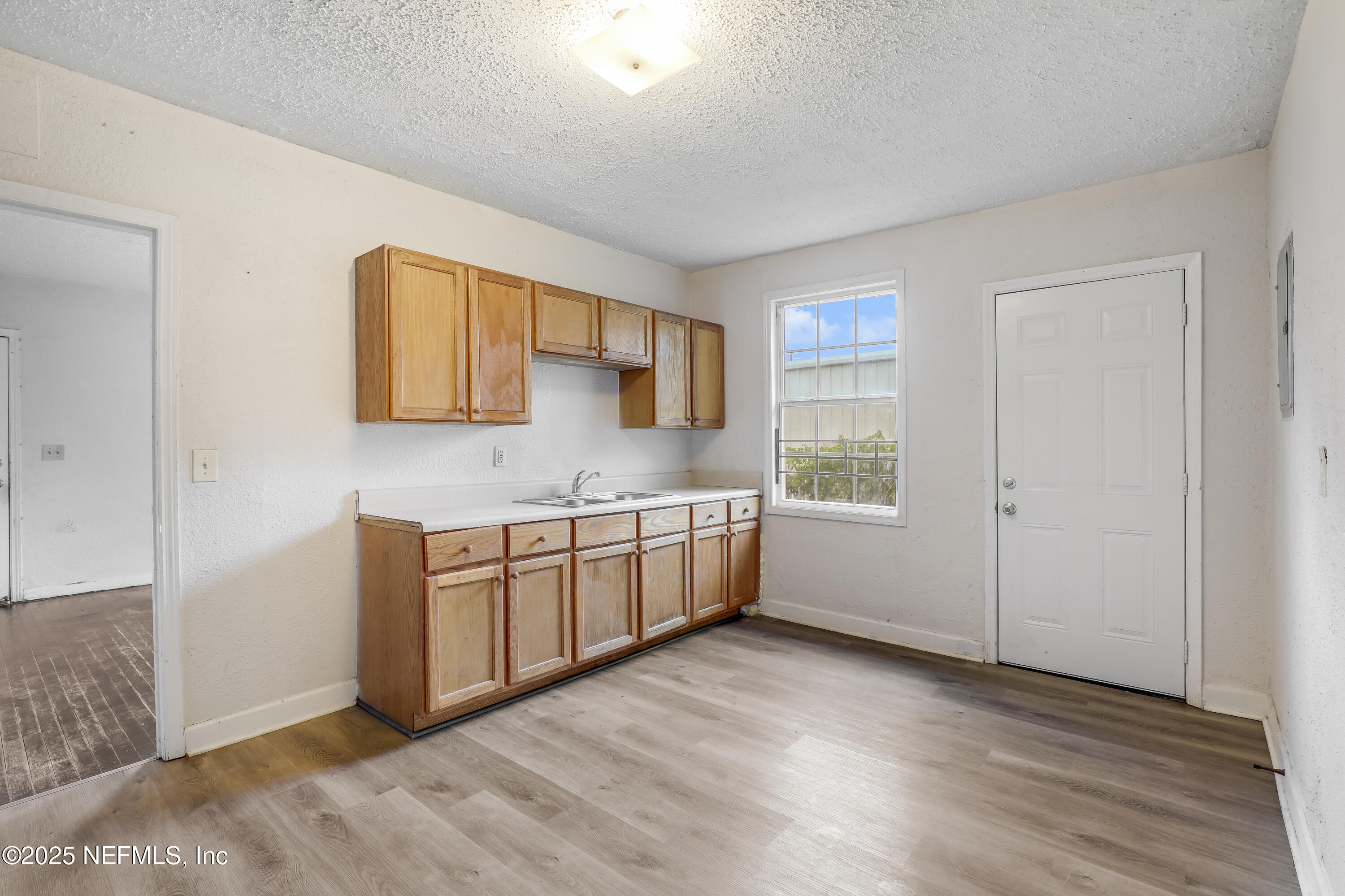 330 West 26th Street Jacksonville, FL 32206 - Photo 3 of 27 a view of an empty room with window and wooden floor