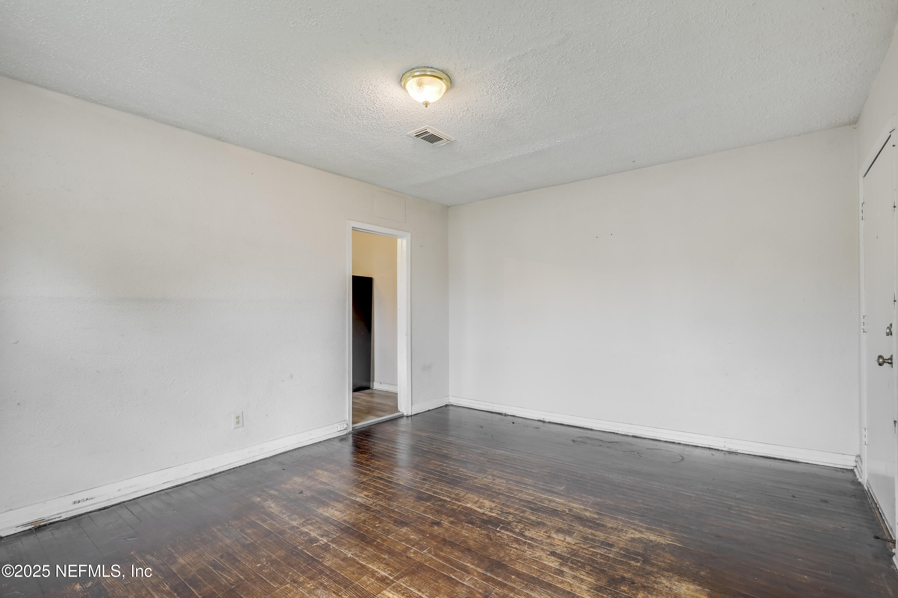 330 West 26th Street Jacksonville, FL 32206 - Photo 8 of 27 a view of an empty room with wooden floor and a window