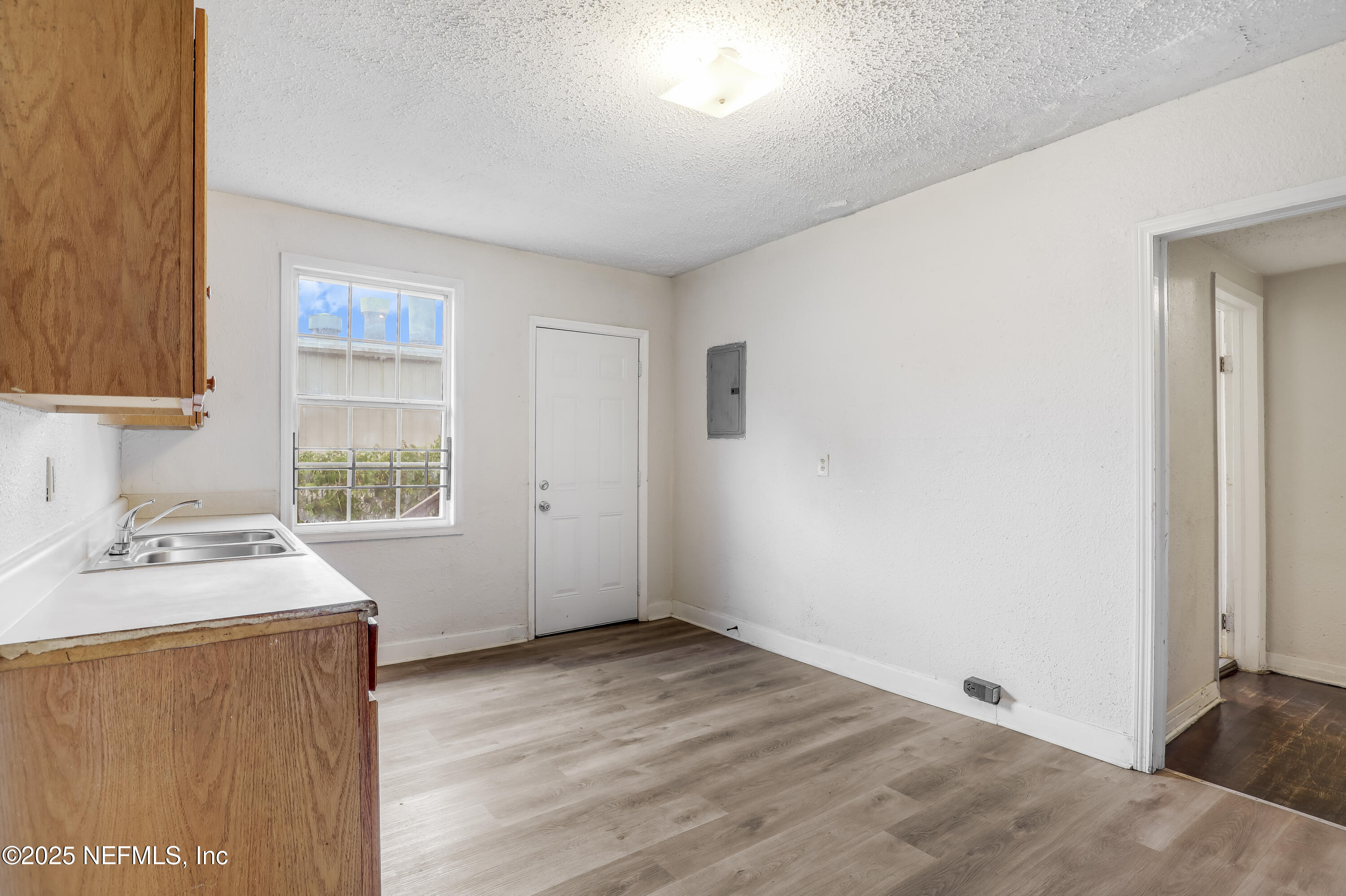 330 West 26th Street Jacksonville, FL 32206 - Photo 9 of 27 a room with a wooden floor and white walls