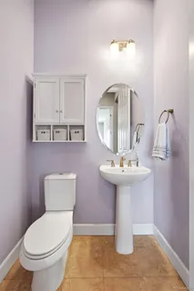 a bathroom with a toilet sink and mirror