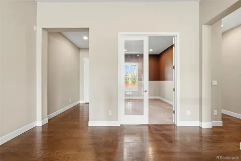 a view of empty room with wooden floor
