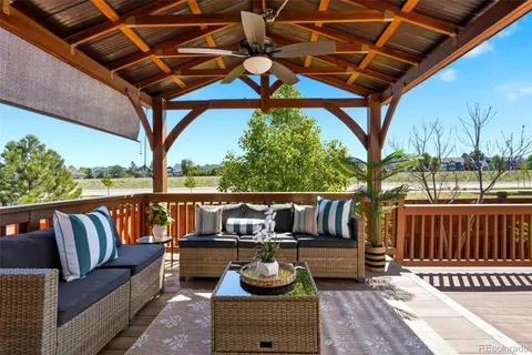a roof deck with couch and chairs
