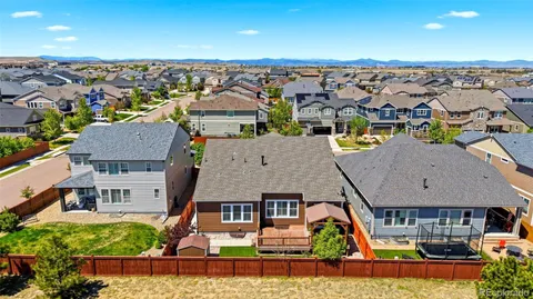 an aerial view of residential houses with outdoor space and parking