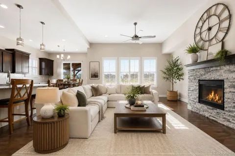 a living room with furniture kitchen view and a fireplace