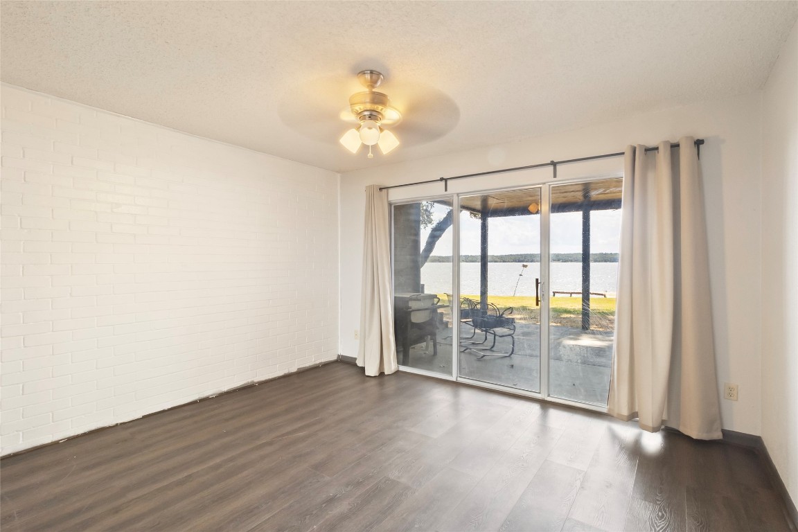 344 Peach Island Trinity, TX 75862 - Photo 11 of 15 wooden floor in an empty room with a window
