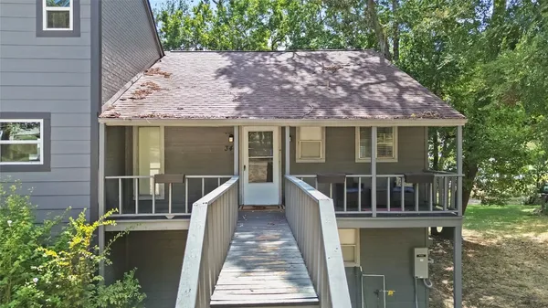 a view of a house with a small deck