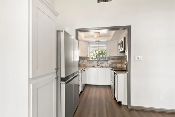 a kitchen with a refrigerator and countertop